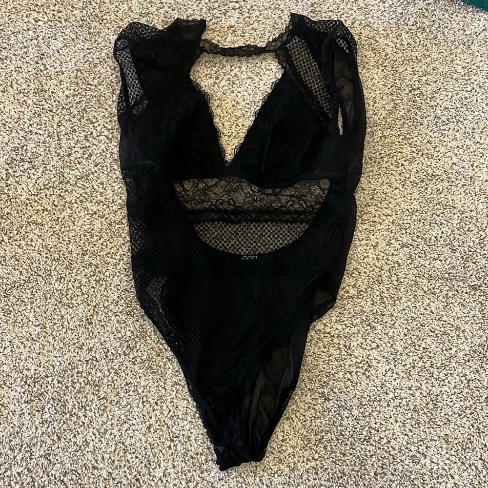 Black mesh body suit, has an open back with hook to support, sleeveless